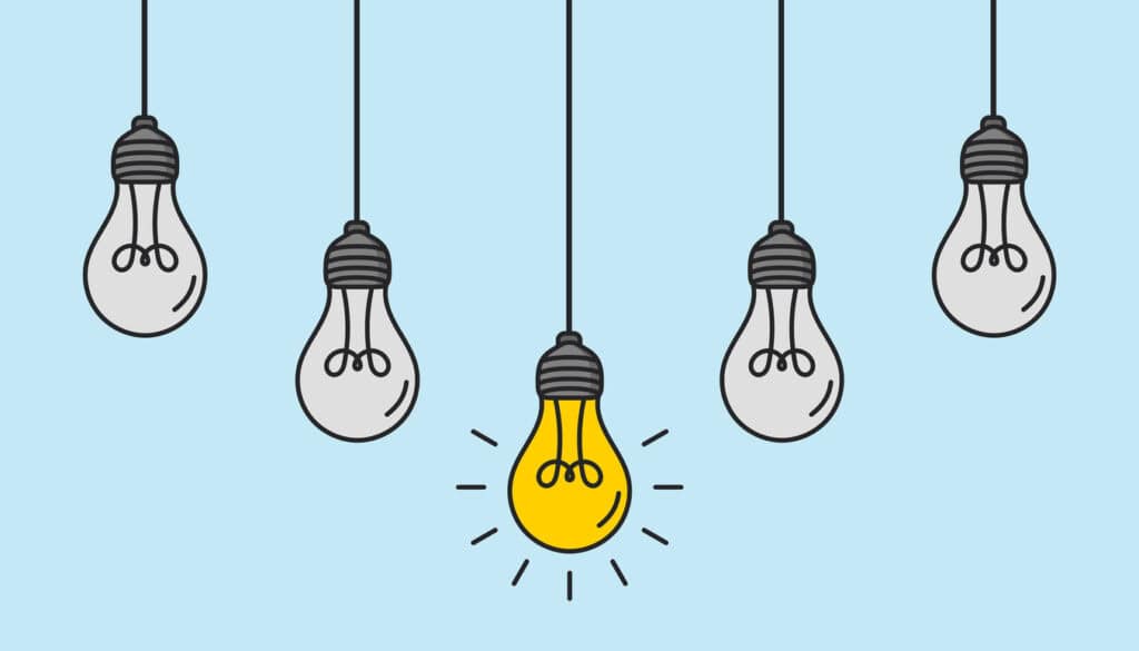 Hanging light bulbs with one glowing on white background. Concept of idea